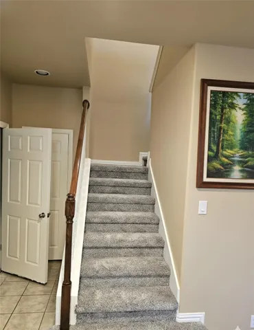 a view of staircase with white walls and windows