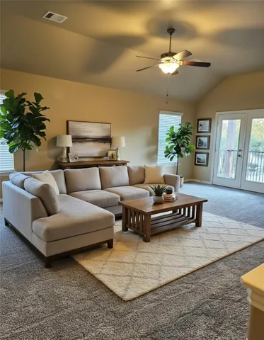 a living room with furniture and a chandelier