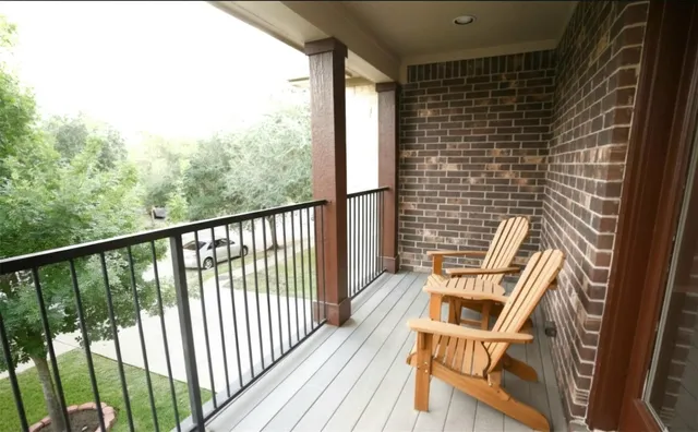 a view of a balcony with wooden floor