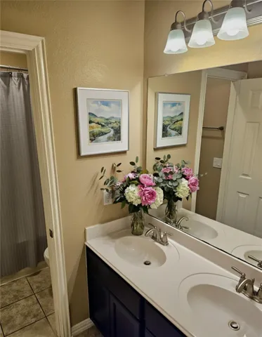 a bathroom with a sink tub and a mirror