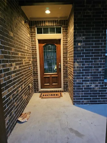 a view of a door and brick wall