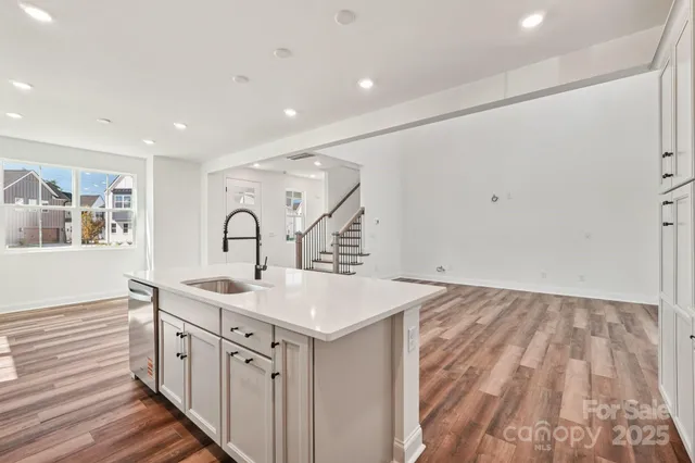a living room with lots of furniture and kitchen view