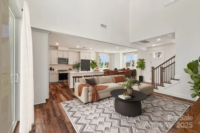 a kitchen with a table chairs a sink and a counter top space