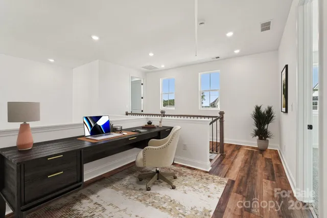 an empty room with closet and windows