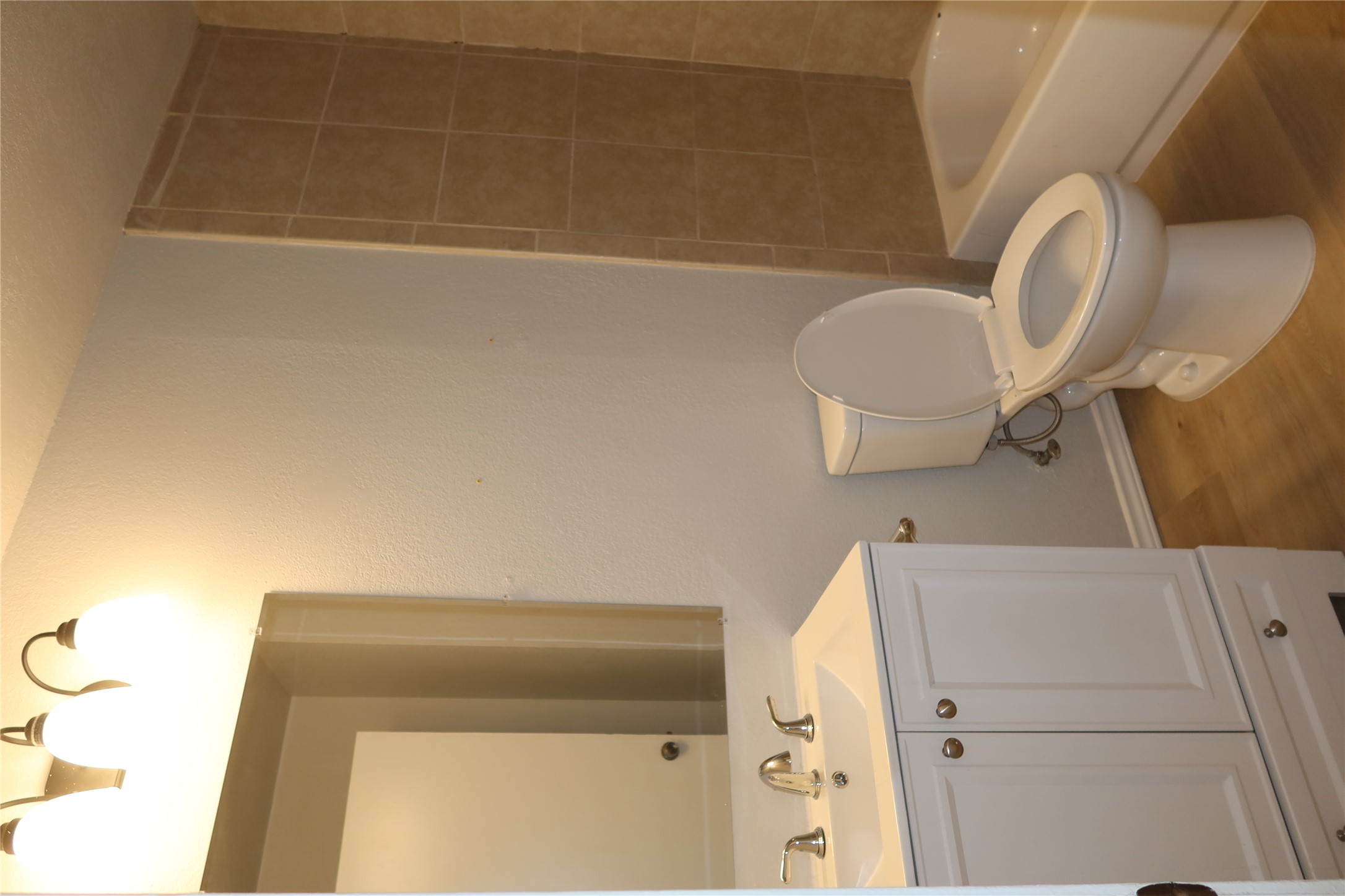 2511 Bucks Run, Unit A Austin, TX 78744 - Photo 16 of 25 Full bathroom featuring vanity, light wood-type flooring, and shower / bath combination