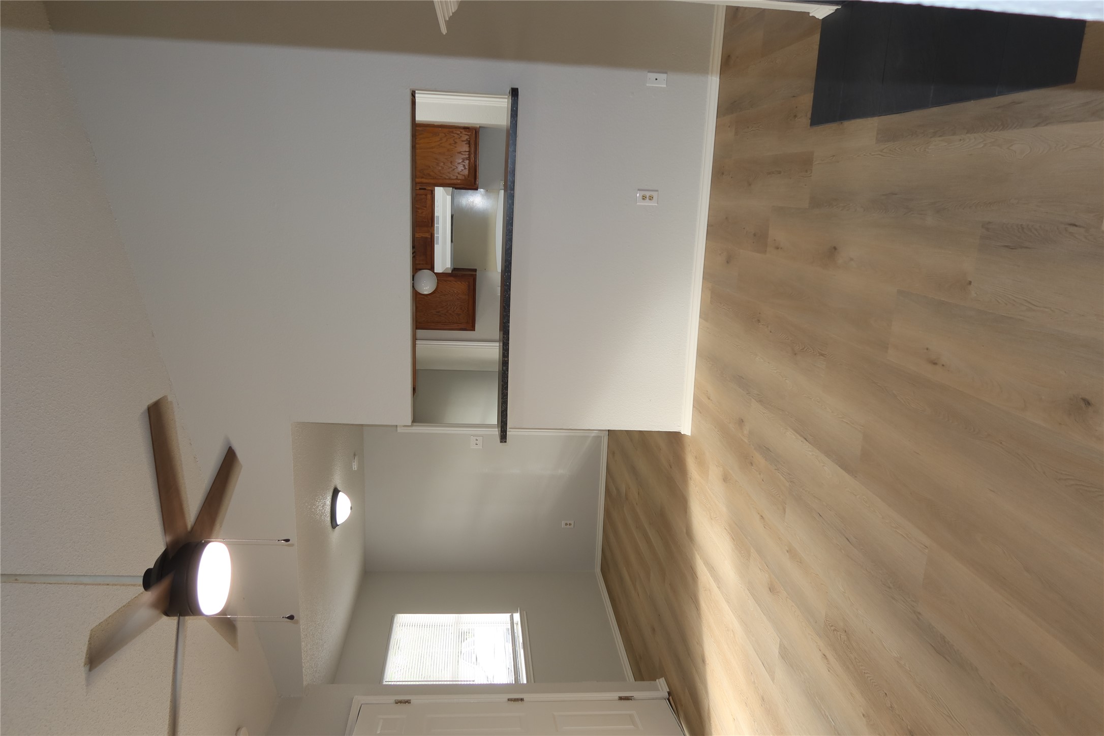 2511 Bucks Run, Unit A Austin, TX 78744 - Photo 19 of 25 Unfurnished living room featuring a ceiling fan and light wood-type flooring