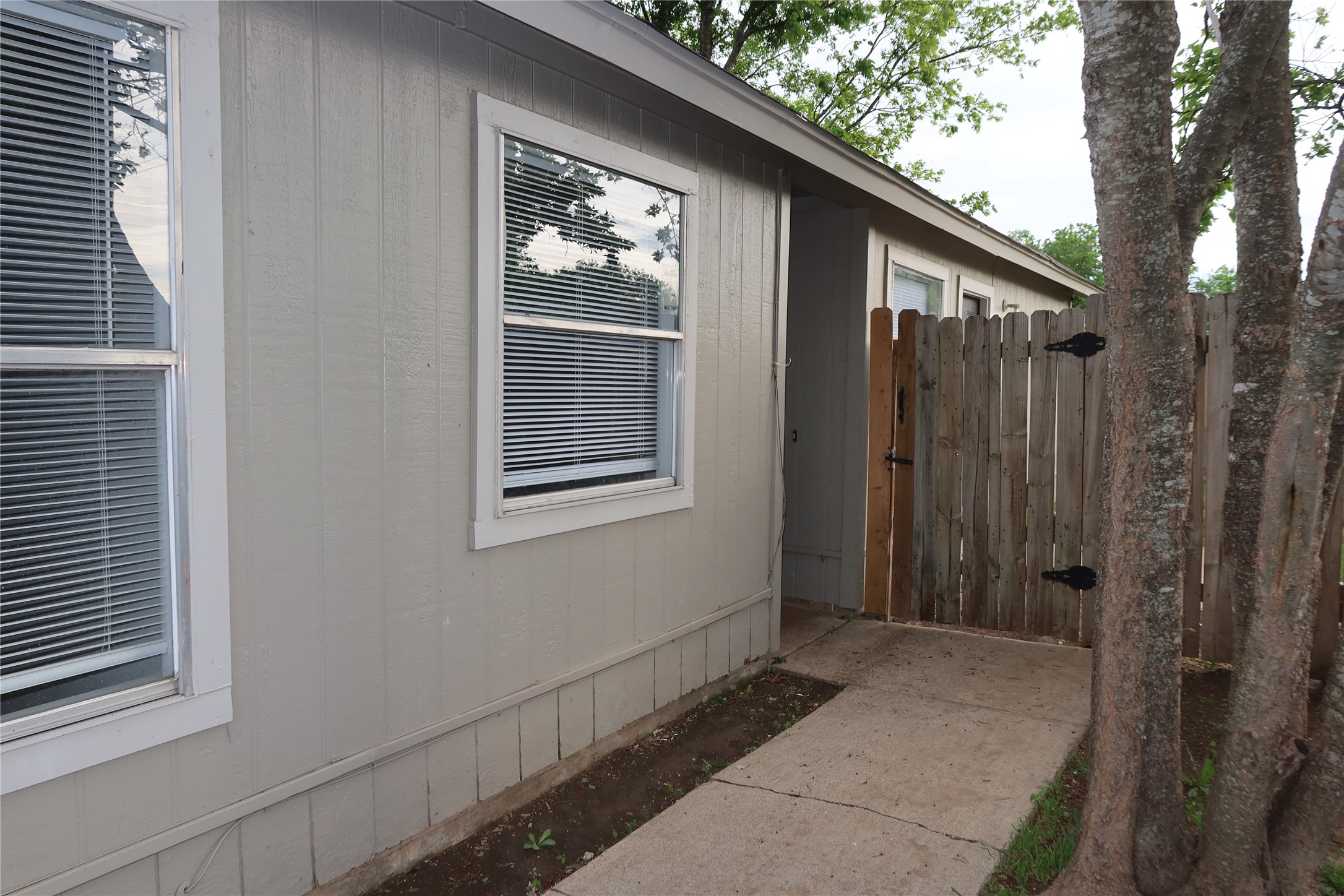 2511 Bucks Run, Unit A Austin, TX 78744 - Photo 23 of 25 View of side of property featuring a gate