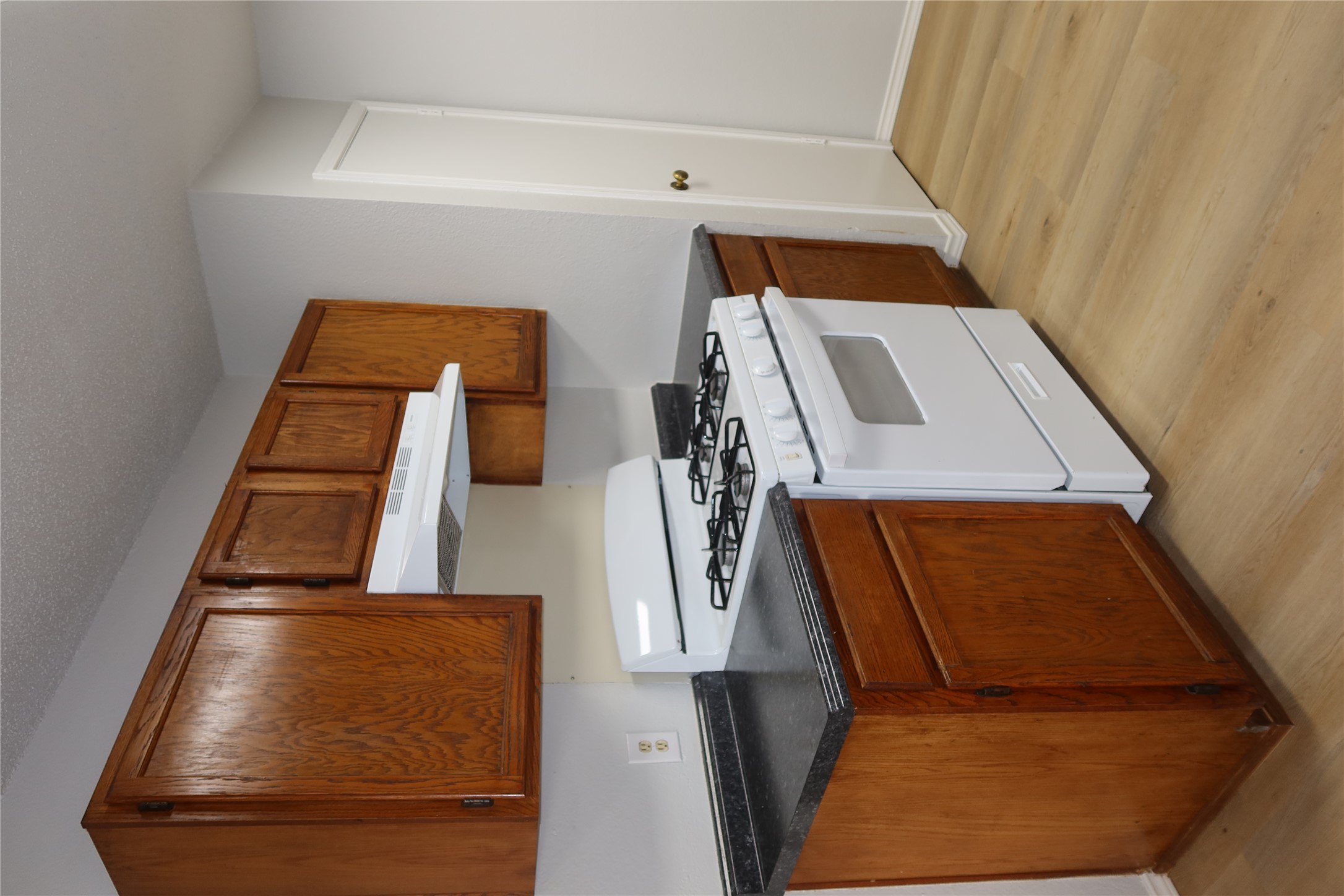 2511 Bucks Run, Unit A Austin, TX 78744 - Photo 7 of 25 Kitchen with white range with gas stovetop, dark countertops, light wood-style flooring, wood finish cabinets, and a textured ceiling