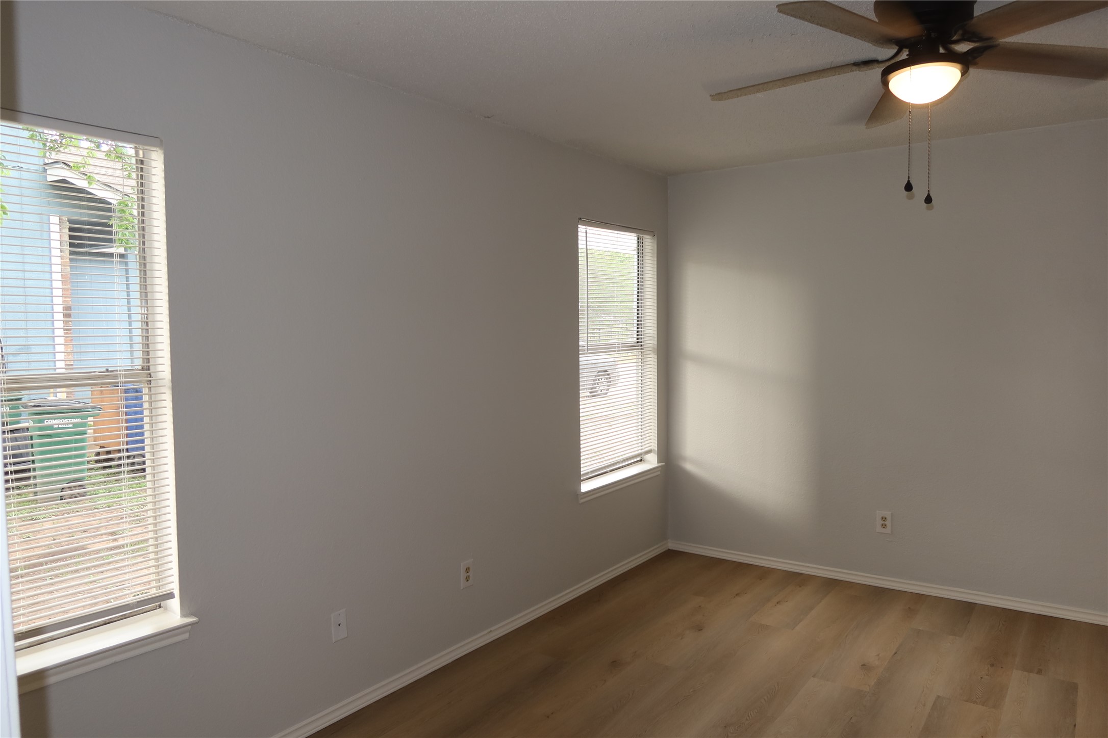 2511 Bucks Run, Unit A Austin, TX 78744 - Photo 9 of 25 Spare room with ceiling fan and wood finished floors