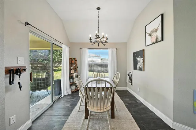 a kitchen with stainless steel appliances granite countertop white cabinets a stove a sink and dishwasher