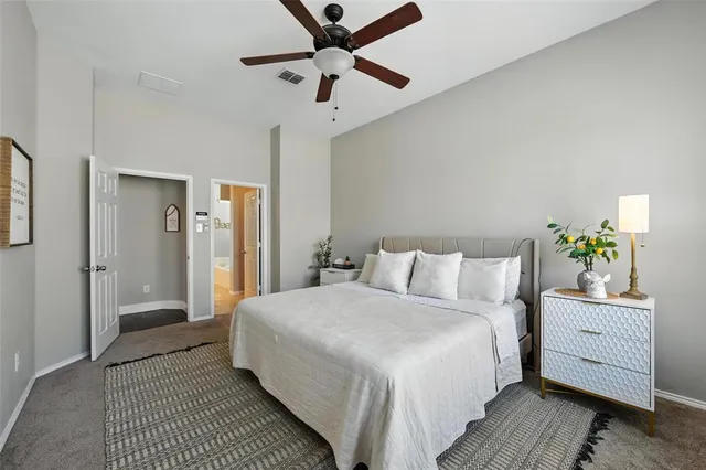 a bedroom with a large bed and a window