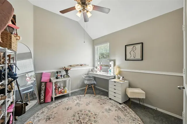 a view of a livingroom with workspace and a flat screen tv