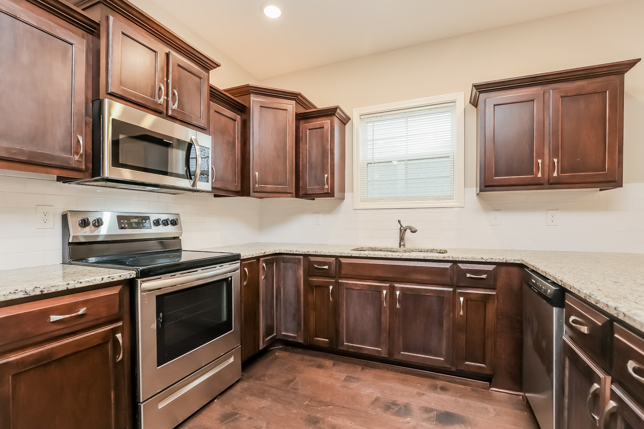 311 Bountiful Smyrna, TN 37167 - Photo 12 of 15 a kitchen with stainless steel appliances granite countertop a stove microwave and sink