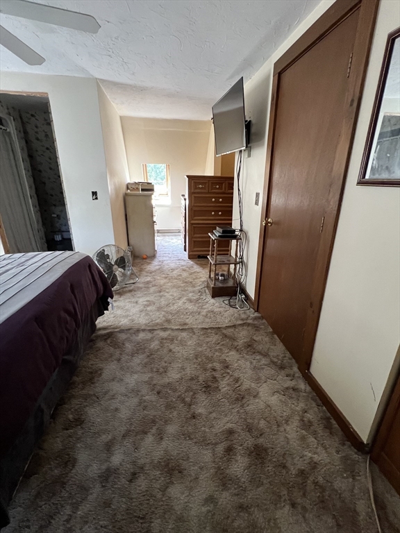 221 Pierce Road West Brookfield, MA 01585 - Photo 25 of 26 a bed room with a bed and a refrigerator