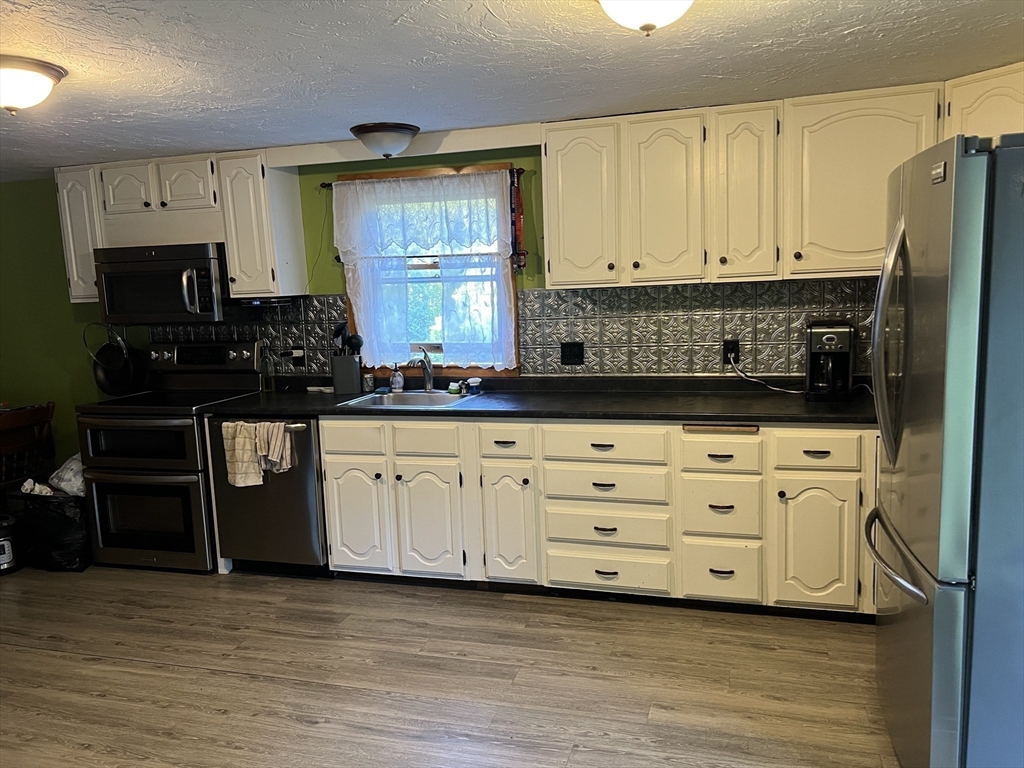 221 Pierce Road West Brookfield, MA 01585 - Photo 3 of 26 a kitchen with granite countertop a stove and a sink