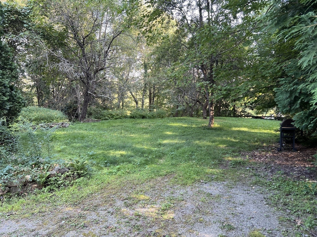 221 Pierce Road West Brookfield, MA 01585 - Photo 9 of 26 a view of a grassy field with trees