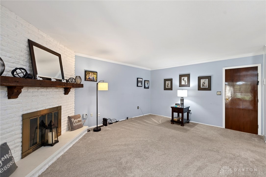 5907 Red Coach Road Dayton, OH 45429 - Photo 21 of 50 This inviting living space features a cozy fireplace, perfect for relaxation and gatherings.