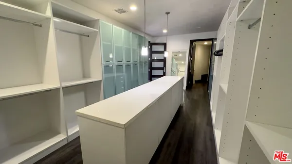 a bedroom with a bed and a walk in closet