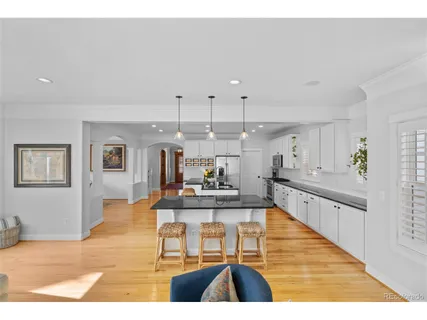 a kitchen with granite countertop a sink stainless steel appliances and cabinets