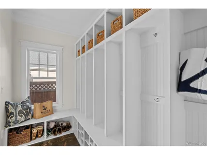 a bedroom with a bed and dresser with mirror