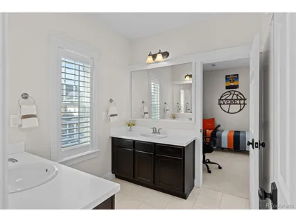 a en suite bathroom with a sink double vanity and a mirror