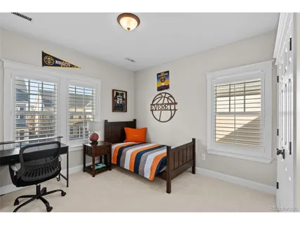 a bedroom with a bed and a lamp with window