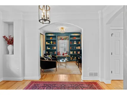 a living room with furniture and a book shelf