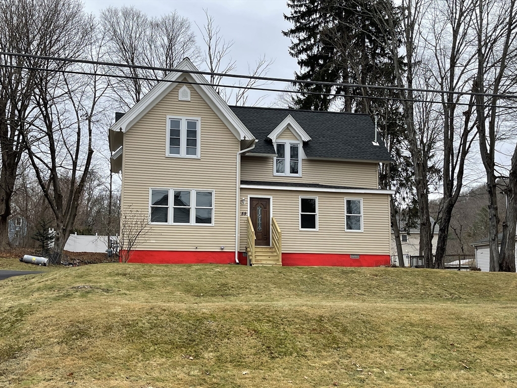 a front view of house with yard and slide