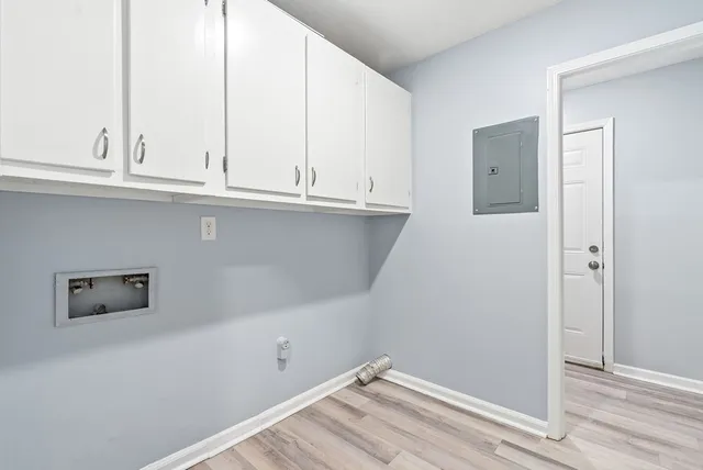 a view of a dry yard with large trees