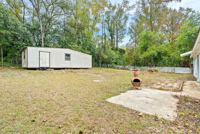 a front view of house with yard and trees