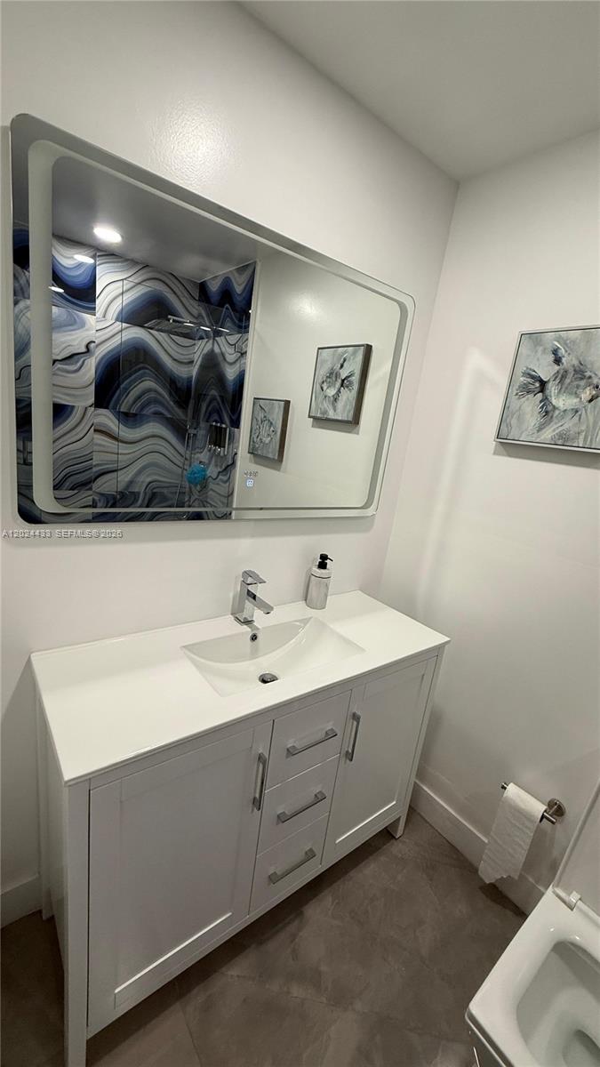 13675 Southwest 62nd Street, Unit 2023 Miami, FL 33183 - Photo 17 of 22 a bathroom with a sink and a mirror