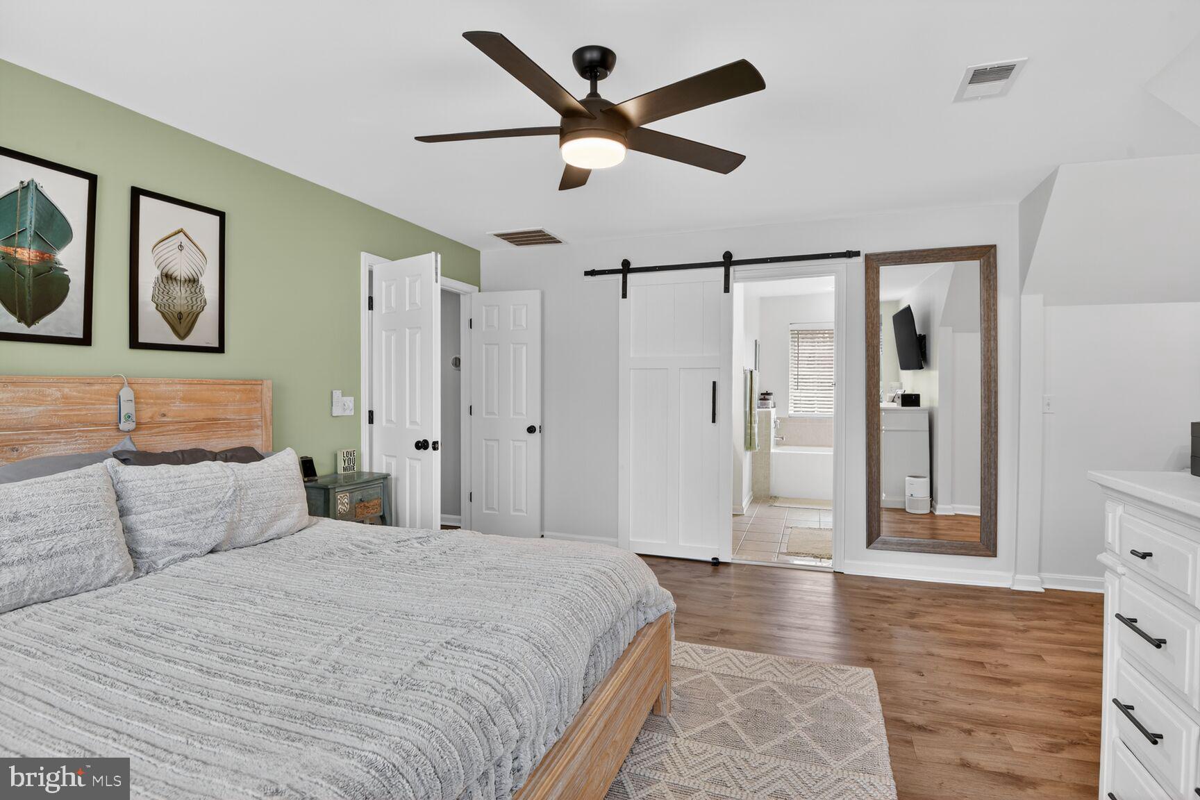1409 James Way Edgewater, MD 21037 - Photo 14 of 21 a spacious bedroom with a bed and a chandelier