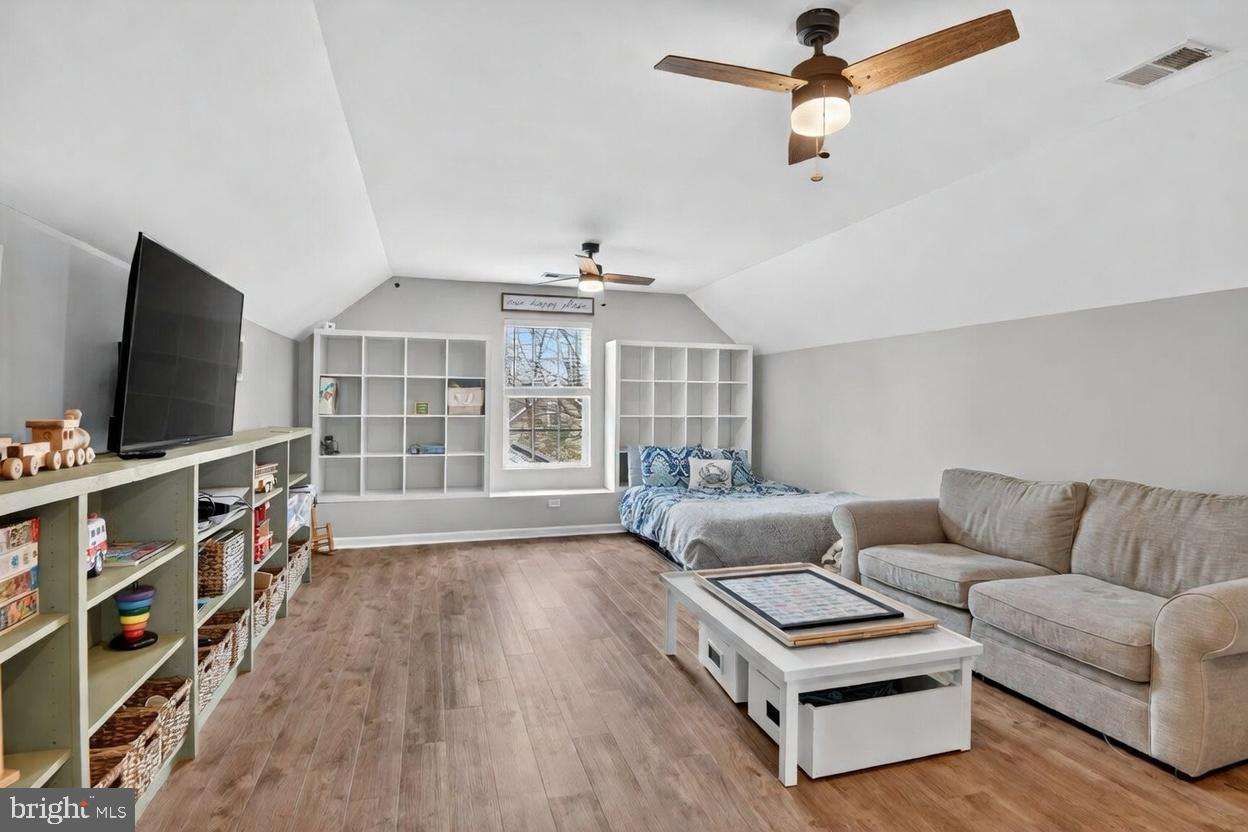 1409 James Way Edgewater, MD 21037 - Photo 17 of 21 a living room with furniture a flat screen tv and a book shelf