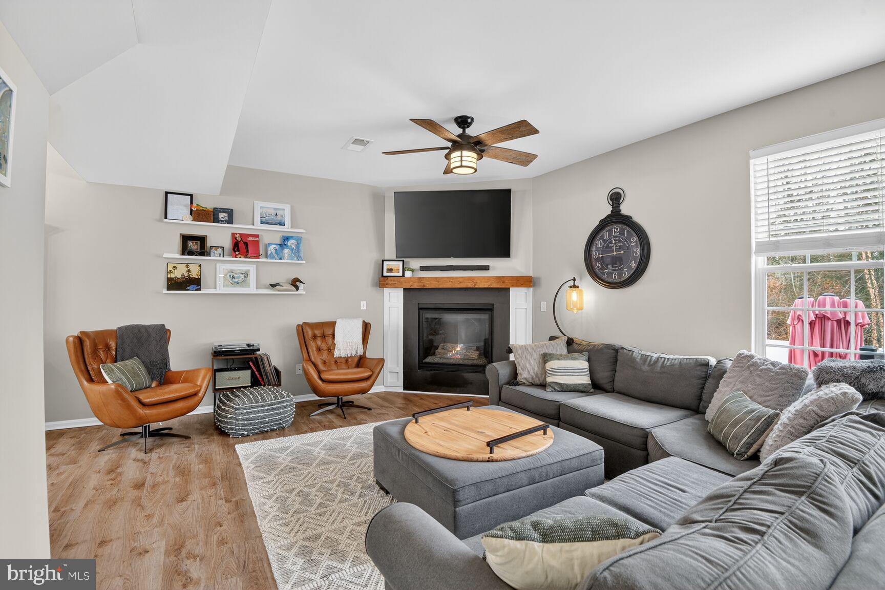 1409 James Way Edgewater, MD 21037 - Photo 3 of 21 a living room with furniture a fireplace and a window