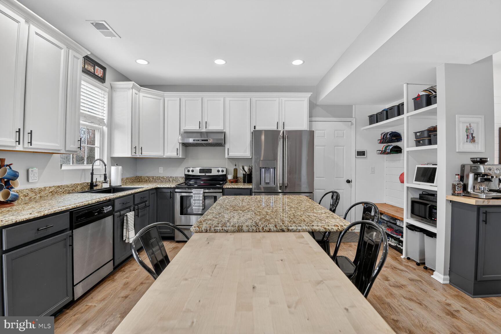 1409 James Way Edgewater, MD 21037 - Photo 7 of 21 a kitchen with kitchen island a counter top space a sink stainless steel appliances and cabinets
