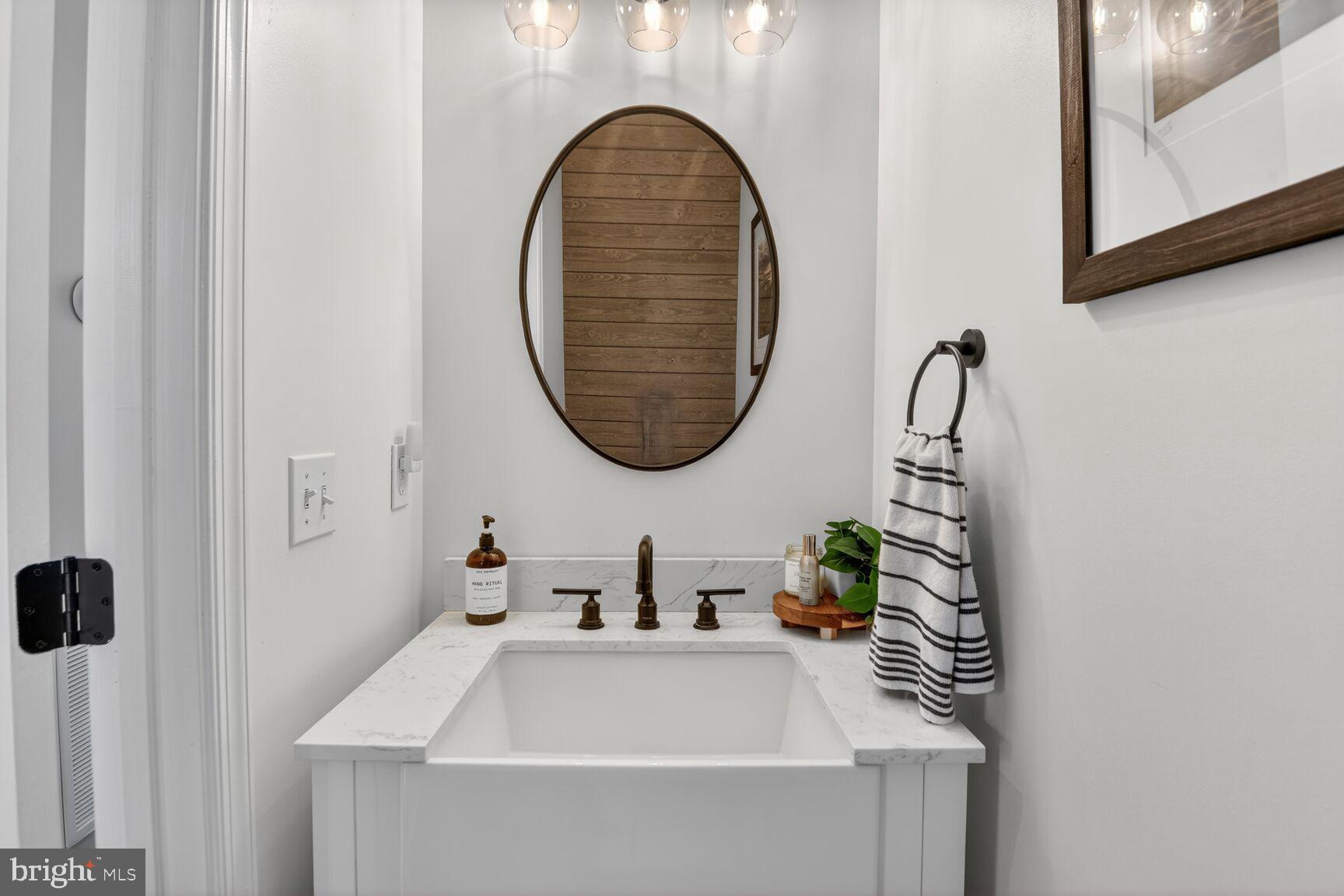 1409 James Way Edgewater, MD 21037 - Photo 8 of 21 a bathroom with a sink and a mirror
