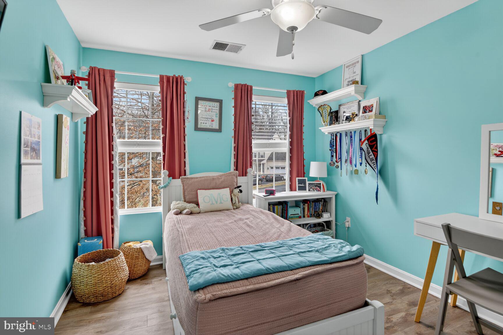 1409 James Way Edgewater, MD 21037 - Photo 9 of 21 a bedroom with a large bed and a chandelier