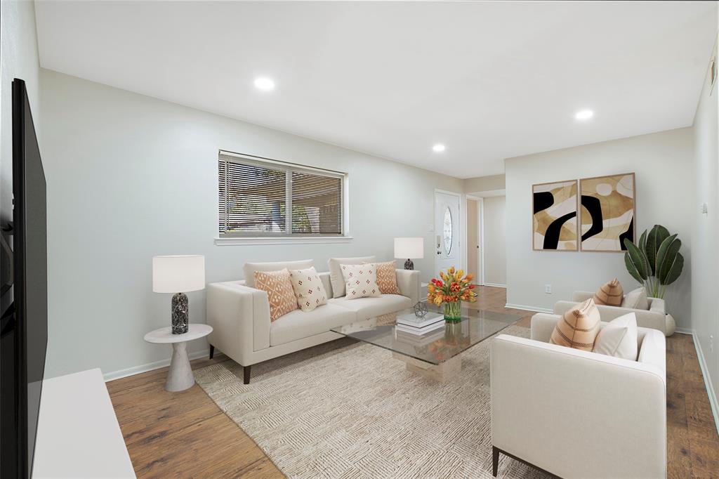 a living room with furniture and a painting on the wall