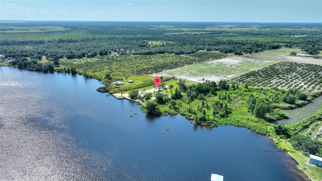 2427 Black Road Fort Meade, FL 33841 - Photo 15 of 26 a view of a lake with a city