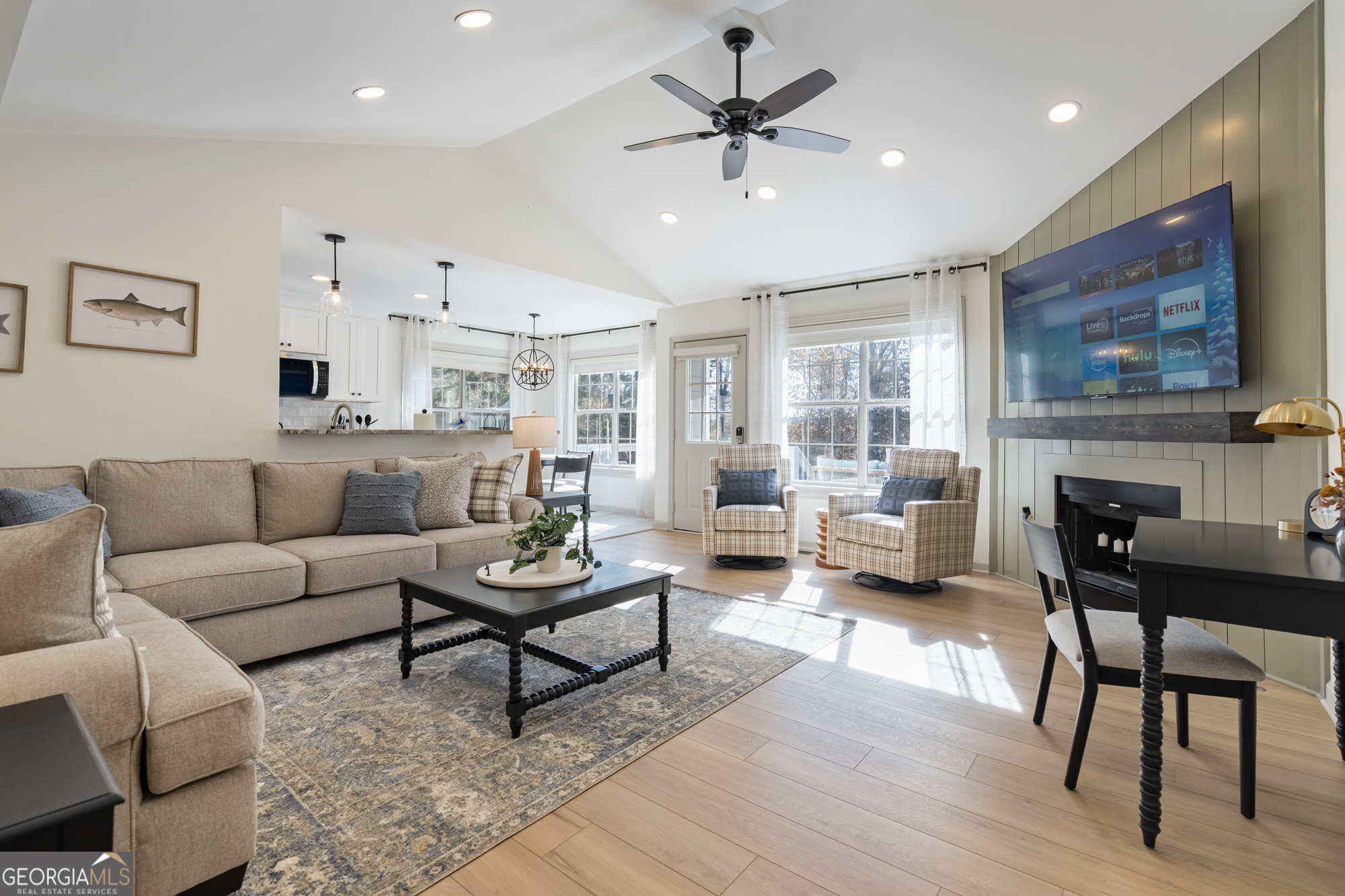 a living room with furniture and a fireplace