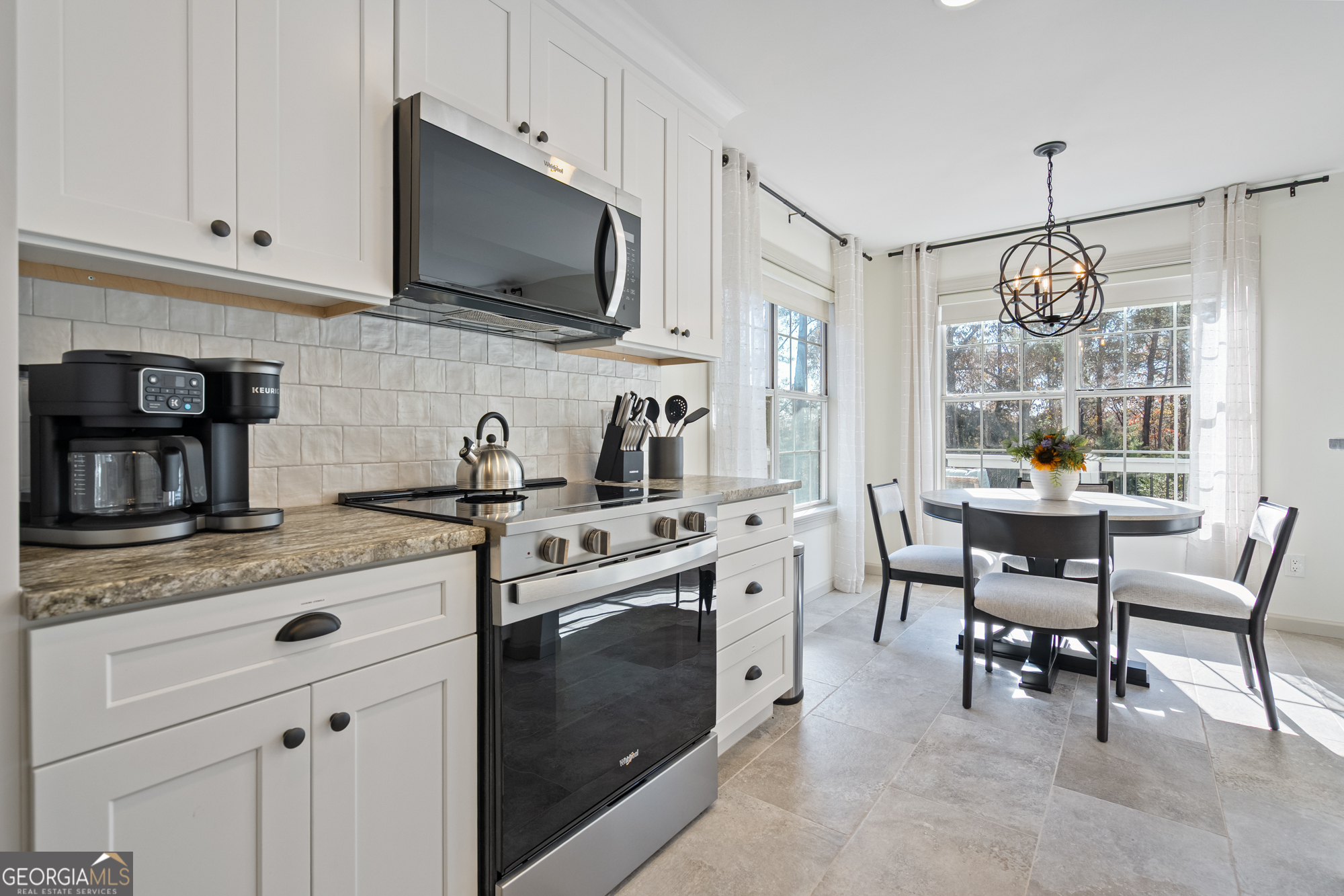 17 North Wesley Ridge Adairsville, GA 30103 - Photo 11 of 30 a kitchen with stainless steel appliances granite countertop a stove top oven a sink dishwasher a dining table and chairs with wooden floor