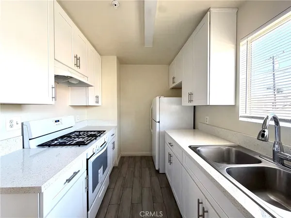a kitchen that has a sink and a stove