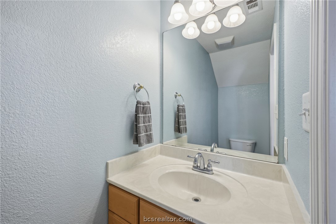 1000 Spring Loop, Unit 2105 College Station, TX 77840 - Photo 9 of 22 a bathroom with a sink vanity and a mirror