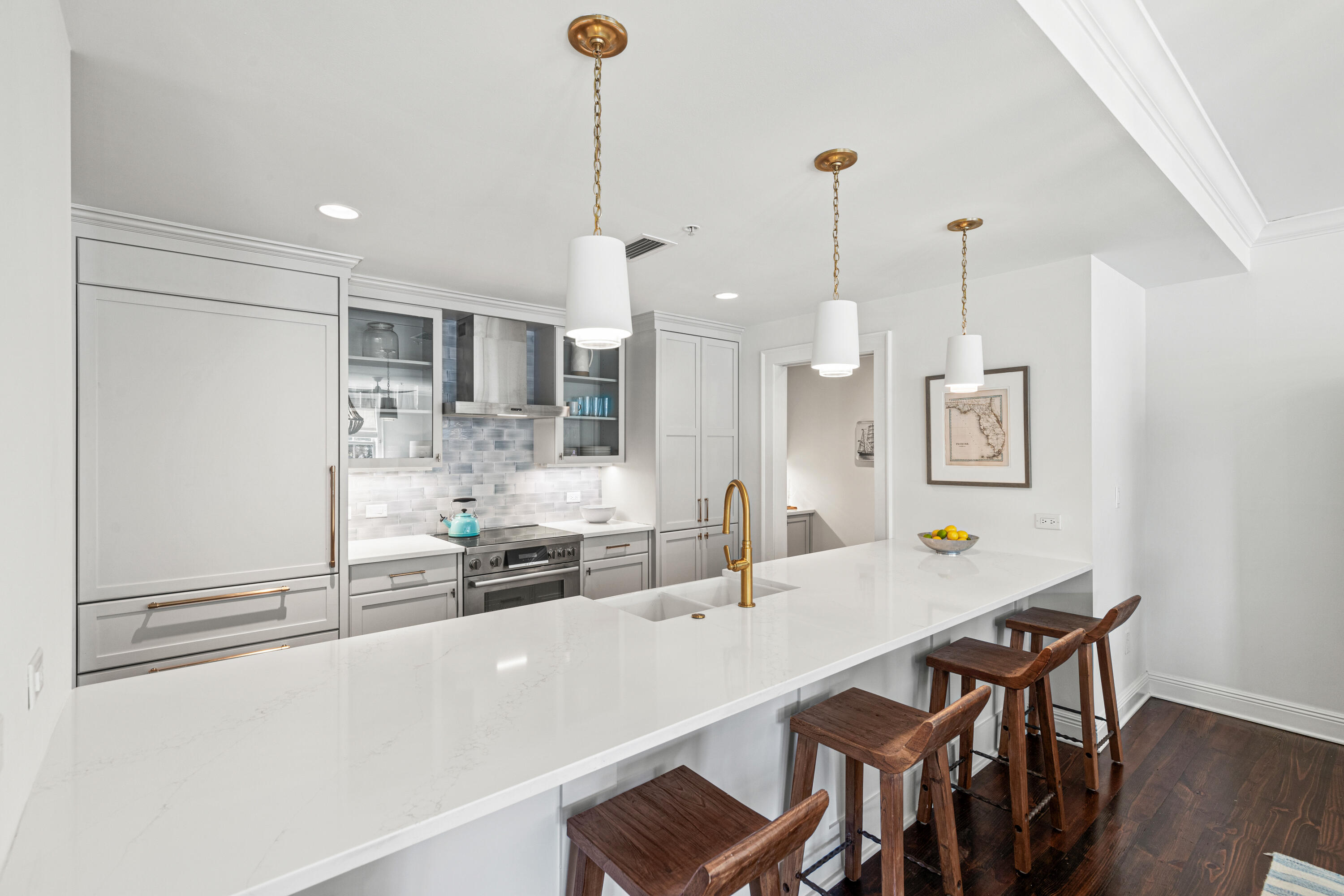 104 North Barrett Square, Unit 2A Inlet Beach, FL 32461 - Photo 16 of 44 a kitchen with kitchen island a table and chairs