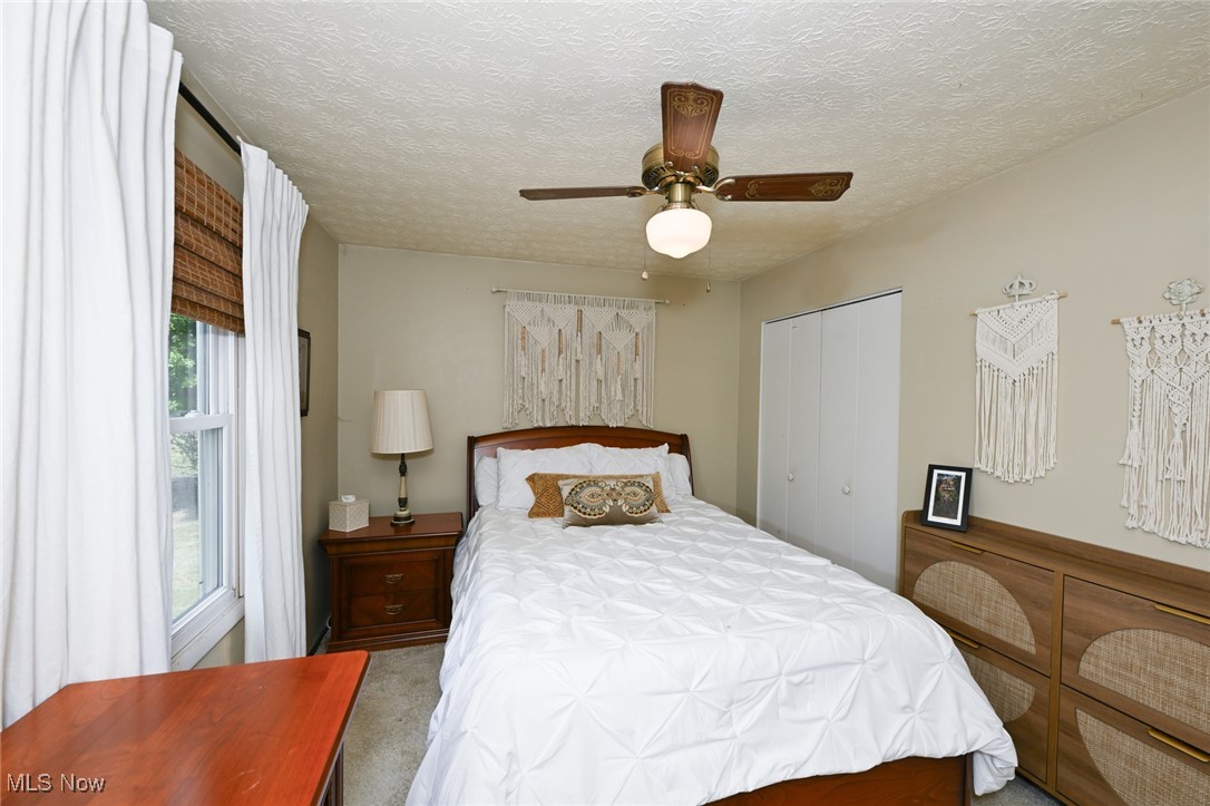 2757 Porter Road Atwater, OH 44201 - Photo 32 of 49 Bedroom featuring carpet flooring, a textured ceiling, a ceiling fan, and a closet