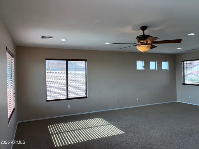 an empty room with windows and closet