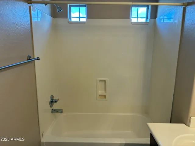 an empty room with a chandelier fan