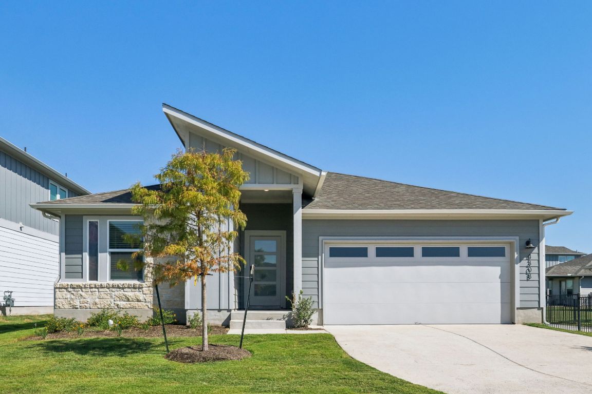 4308 Forel Road Pflugerville, TX 78660 - Photo 1 of 1 View of front of house featuring a garage, concrete driveway, roof with shingles, and board and batten siding