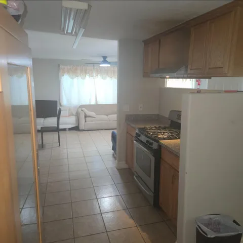 a kitchen with stainless steel appliances a stove a sink and a refrigerator