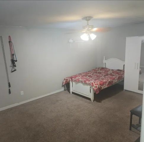 a bed sitting in a room next to a lamp